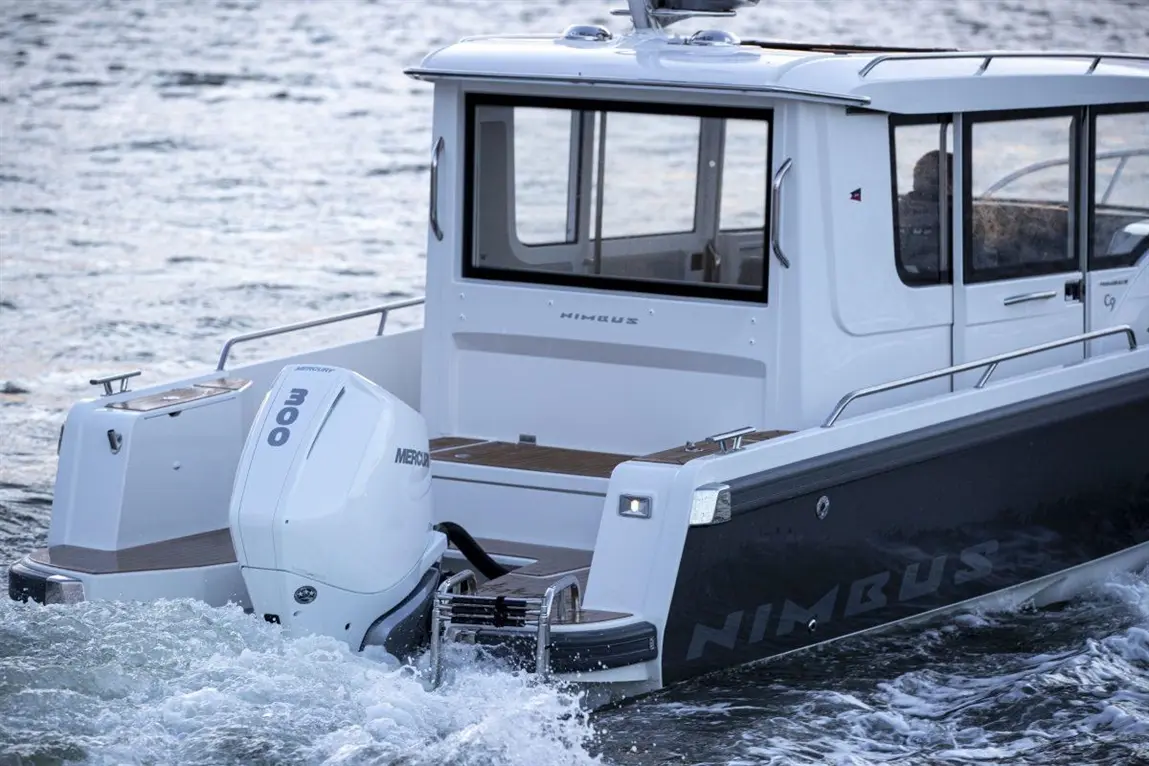 Nimbus boat with a Mercury 300 engine, cutting through water, showcasing sleek design and modern features.